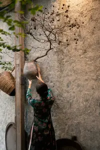 Elegant Asian Beauty: Serene Woman in Modernized Traditional Dress with Vintage Floral Vase-12