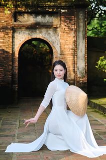 Elegant Vietnamese Woman in Traditional White Ao Dai, Gracing an Ancient Pathway | 1000017528-6