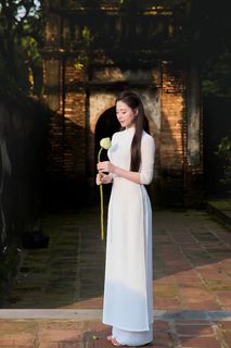 Elegant Vietnamese Woman in Traditional White Ao Dai, Gracing an Ancient Pathway | 1000017528-0