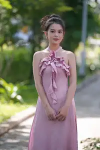 Gentle Charm: A Girl in an Elegant Pink Dress Amidst Nature's Embrace-2