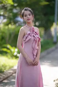 Gentle Charm: A Girl in an Elegant Pink Dress Amidst Nature's Embrace-1