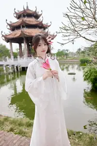 Elegant White Ao Dai with Pink Lotus Flower Embracing Cultural Heritage-3