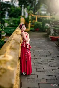 Elegant Asian Beauty in Red Dress Shines Gracefully Amidst a Traditional Garden 1000024509-5