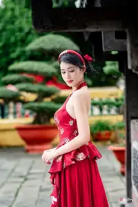 Elegant Asian Beauty in Red Dress Shines Gracefully Amidst a Traditional Garden 1000024509-0