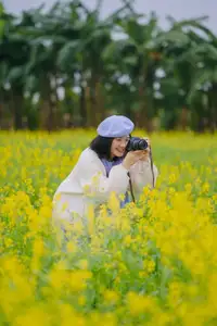 Immerse in Golden Rapeseed Fields: Girl's Artistic Photography Amidst Peaceful Charm, Attracting Year-End Visitors.-1
