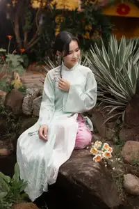 Graceful Vietnamese Woman in Light Green Ao Dai Amidst Tranquil Garden-2