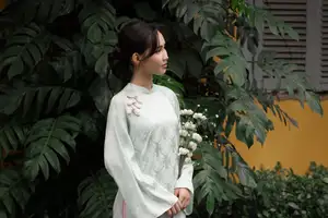 Graceful Vietnamese Woman in Light Green Ao Dai Amidst Tranquil Garden-1