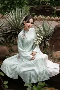 Graceful Vietnamese Woman in Light Green Ao Dai Amidst Tranquil Garden-3