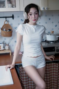 Young Woman Relaxing with Headphones & Music in Cozy Kitchen: Serene Home Lifestyle Moment-6