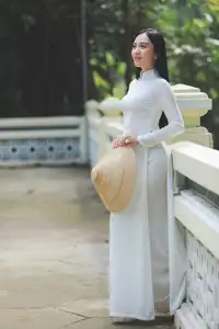 Elegant Vietnamese Woman in White Ao Dai: A Portrait of Traditional Grace and Conical Hat-7