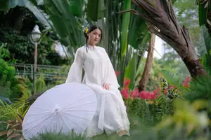 Vietnamese Beauty: Elegant Girl in White Ao Dai, Conical Hat with Yellow Flowers in Ancient Garden-7