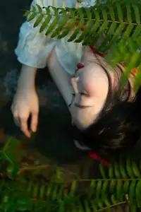 Elegant Woman in White Dress Amidst Lush Green Nature-1