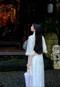 Graceful Vietnamese Woman in White Ao Dai with Lotus Flower in Serene Garden-2