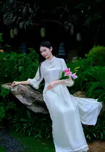 Graceful Vietnamese Woman in White Ao Dai with Lotus Flower in Serene Garden-1
