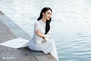 Elegant Vietnamese girl in traditional white Ao Dai by the lake, embodying cultural beauty-7