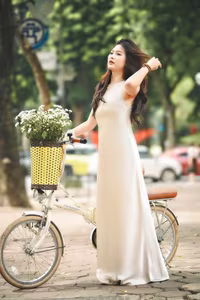 VGU No.54: Elegant Vietnamese Girl with White Chrysanthemums, A Gentle Moment by Bicycle Amidst Greenery.-0