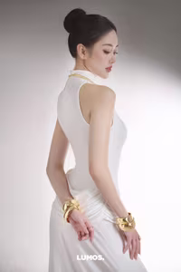 VGU No.53: Elegant beauty in a pristine white dress, posing glamorously on a luxurious black chair. Explore the sophisticated style of the modern woman.-2
