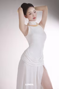 VGU No.53: Elegant beauty in a pristine white dress, posing glamorously on a luxurious black chair. Explore the sophisticated style of the modern woman.-1