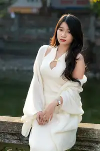 Elegant Beauty in Pristine White Dress Under Golden Afternoon Sun 1000027006-2