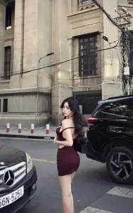 Charming Woman in Elegant Burgundy Mini Dress Defines Urban Street Style-7