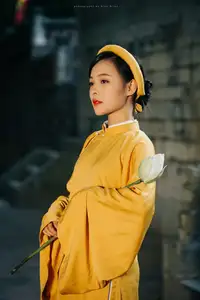 Discover the Graceful Beauty of a Vietnamese Woman in Radiant Yellow Ao Dai with Pure Lotus 1000025235-0