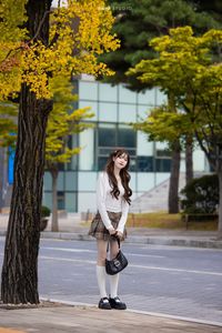 Young Asian Girl in Plaid Skirt Embracing Autumn Foliage-13