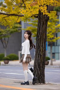 Young Asian Girl in Plaid Skirt Embracing Autumn Foliage-7