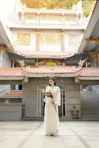 Serene Vietnamese Beauty: A Gentle Muse in White with Pink Lilies-7