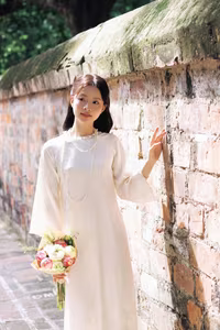 VGU No.131: Graceful young woman in traditional dress, timeless Vietnamese beauty against ancient brick.-5