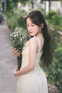 Graceful Girl in Light Yellow Dress with White Flowers, Ethereal Beauty in Nature-3