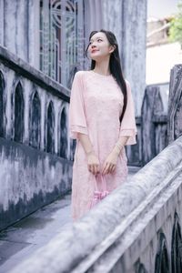 Elegant Woman in Pink Ao Dai at Hanoi Grand Cathedral - Vietnamese Cultural Charm-5
