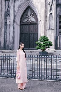 Elegant Woman in Pink Ao Dai at Hanoi Grand Cathedral - Vietnamese Cultural Charm-8