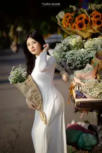 Captivating Beauty: Vietnamese Girl in White Ao Dai with Delicate Daisies.-10