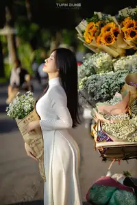 Captivating Beauty: Vietnamese Girl in White Ao Dai with Delicate Daisies.-13
