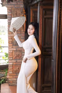 VGU No.108: Pristine White Ao Dai Elegance A Graceful Vietnamese Woman in Traditional Setting-7