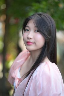 Radiant smile of a young, elegant Vietnamese girl in a pink and white dress.-9