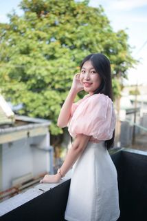 Radiant smile of a young, elegant Vietnamese girl in a pink and white dress.-8