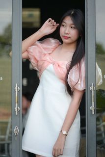 Radiant smile of a young, elegant Vietnamese girl in a pink and white dress.-14