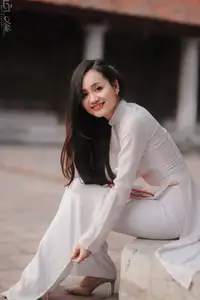 Graceful Vietnamese Girl in White Ao Dai, Radiant Smile at Ancient Site 1000026917-2