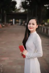 Graceful Vietnamese Girl in White Ao Dai, Radiant Smile at Ancient Site 1000026917-0