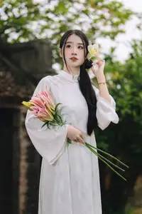 Discover the Grace of a Vietnamese Woman in White Ao Dai with Elegant Lilies-7