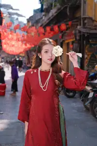 Elegant Vietnamese Beauty: A Girl in Red Ao Dai with Lilies Captivates Urban Charm-4