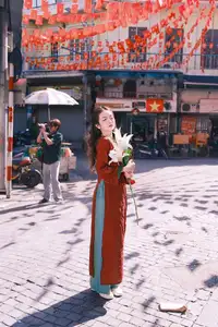Elegant Vietnamese Beauty: A Girl in Red Ao Dai with Lilies Captivates Urban Charm-5