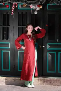 Elegant Vietnamese Beauty: A Girl in Red Ao Dai with Lilies Captivates Urban Charm-6