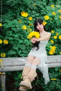 Graceful Young Woman in White Dress Amidst Vibrant Yellow Flowers 1000026997-8