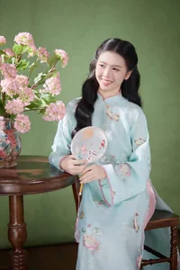 Radiant Elegance in Traditional Blue Attire and Spring Blooms-4