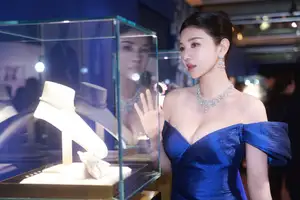 Radiant in Blue: A Woman's Elegant Charm Shines Bright in a Luxurious-4