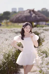 Serene Beauty: Young Woman in White Flower Field, Embracing Tranquility Under Gentle Sunlight-5