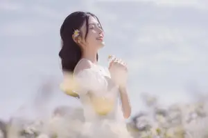 Serene Beauty: Young Woman in White Flower Field, Embracing Tranquility Under Gentle Sunlight-0