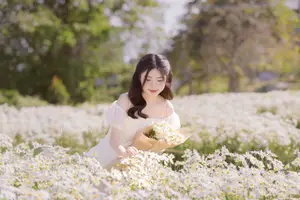 Serene Beauty: Young Woman in White Flower Field, Embracing Tranquility Under Gentle Sunlight-6